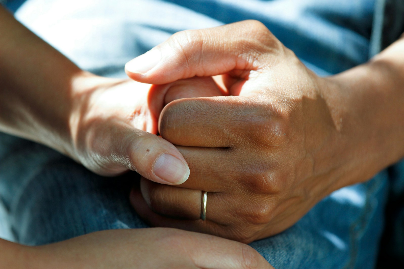 person wearing gold wedding band life